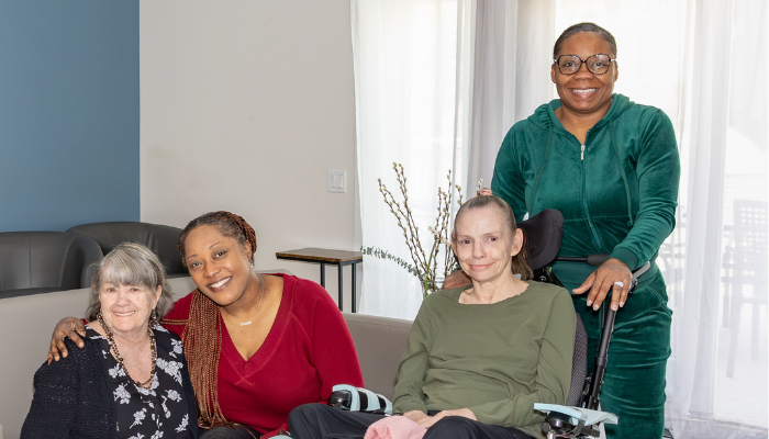 Two residents and two staff members in a TILL group home